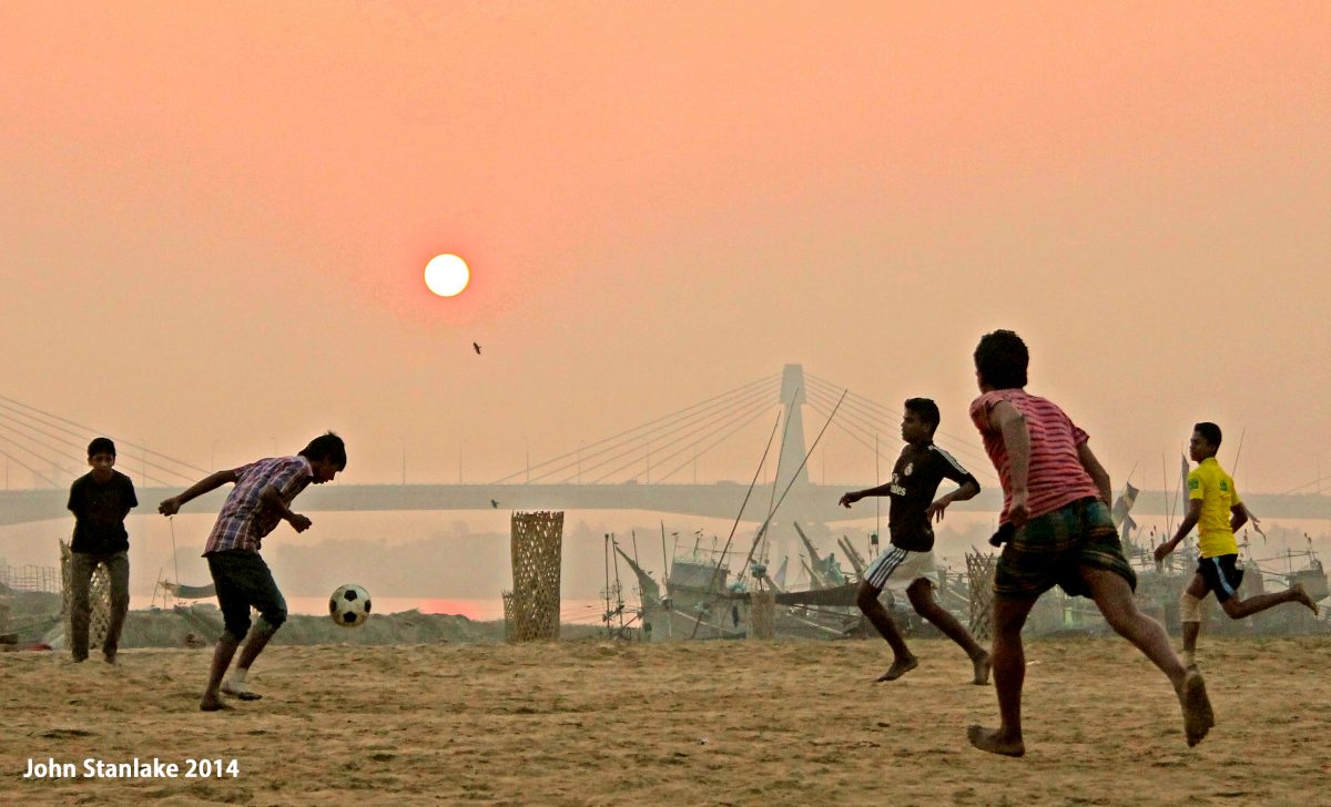 Sunrise Sports: A common sight across Bangladesh of people taking advantage of the cooler air at dawn to engage in early morning sport and exercise. While cricket holds ground, football can be seen gaining popularity on beaches and empty plots of land across the country. 