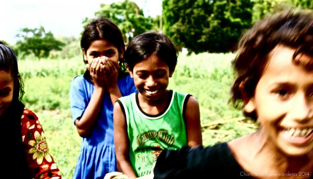 Caught Smiling: As a woman, Chanchala is more likely than John to receive permission from women to photograph them. She met these young girls in the Chittagong countryside where they made a very serious endeavour to strike a solemn pose. Using her poor Bangla skills to break the ice, Chanchala managed to capture this brief shot of them in a relaxed and humourous moment.