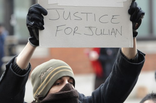 Julian-Assange-supporter-with-Justice-For-Julian-sign-photo-EPA-500x330