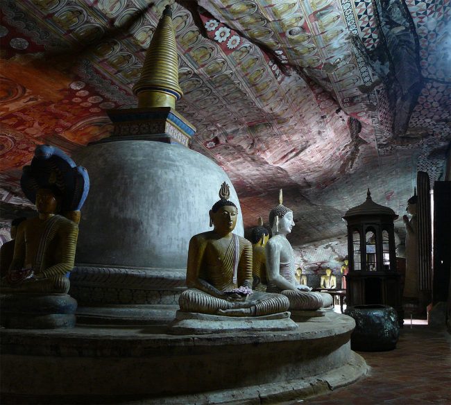 Statues of the Buddha in the Cave of the Great Kings. The intricate murals covering the stone walls depict scenes from the Buddha’s life. Image courtesy: wikimedia.org