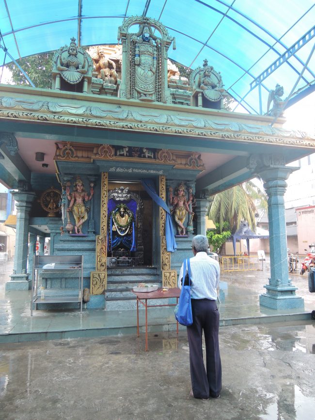 A devotee praying at the temple during Kandha Shasthi Viratham. 