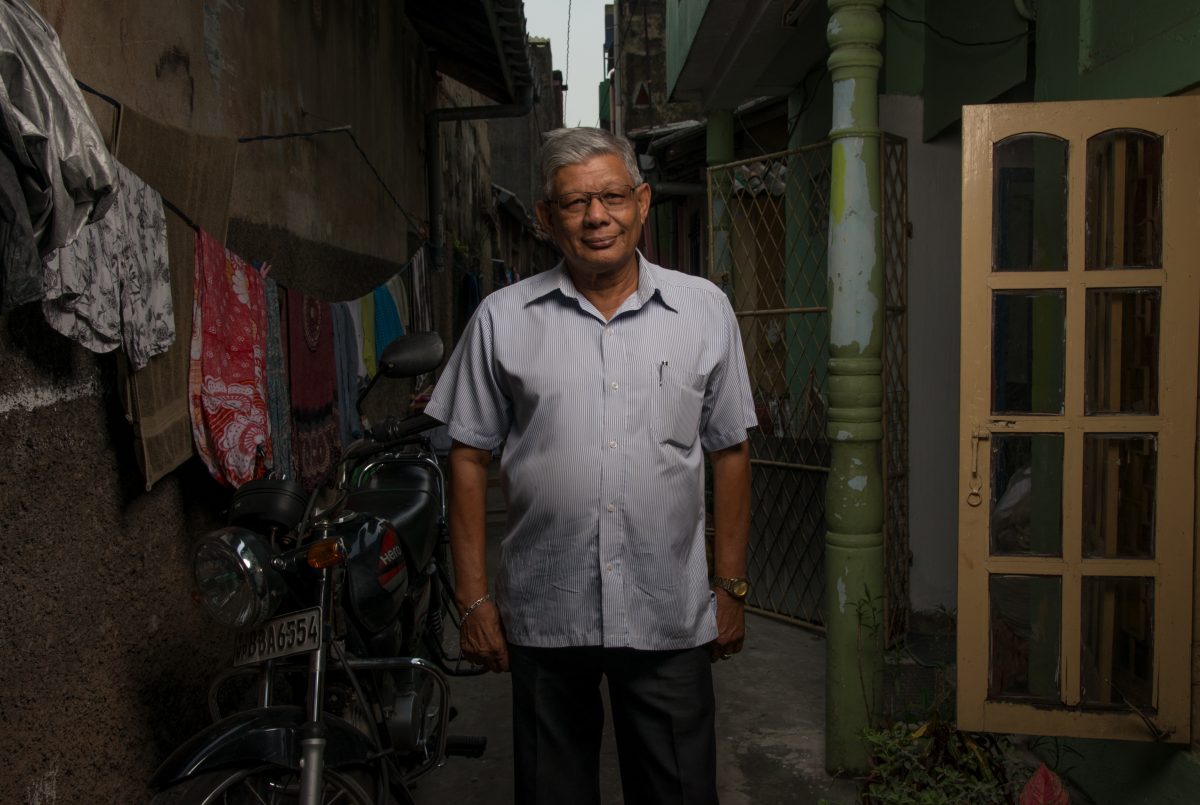 Tuan stands in the alleyway in front of his house in Slave Island. Image credit: Roar.lk/Christian Hutter