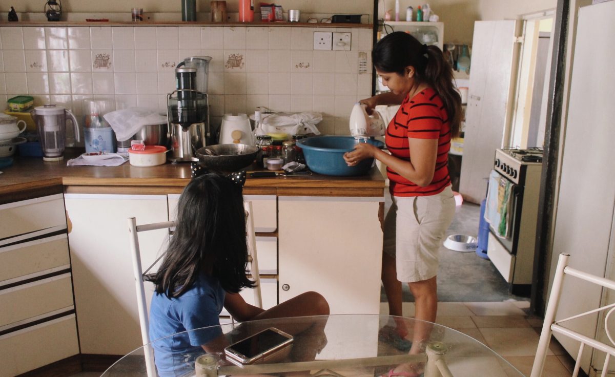 For Vanessa De Silva, food is a big part of the lead up to Christmas – as a home baker, a good part of her December is spent in the kitchen. Here, she is pictured preparing Christmas cake batter, as her daughter Aanya looks on. The recipe, which was passed down to Vanessa from her mother, will eventually be passed down to Aanya, who is being given a head start in the kitchen. Minaali Haputantri / Roar.lk