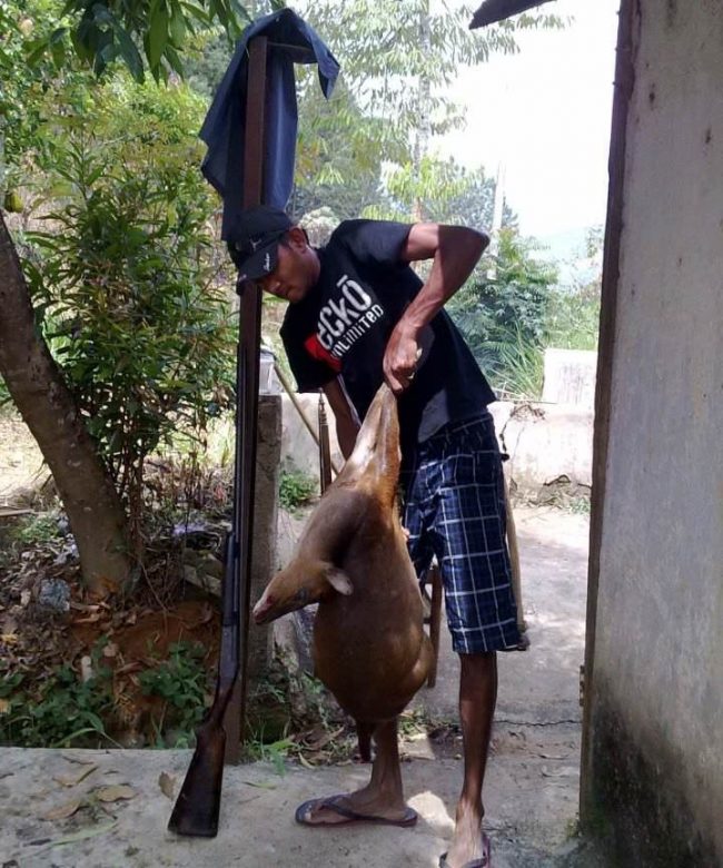 One of the hunters with an animal they'd killed. Image courtesy sinhayareader.com